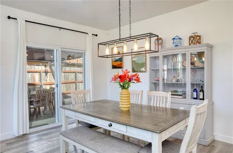 a view of a dining room with furniture and a potted plant