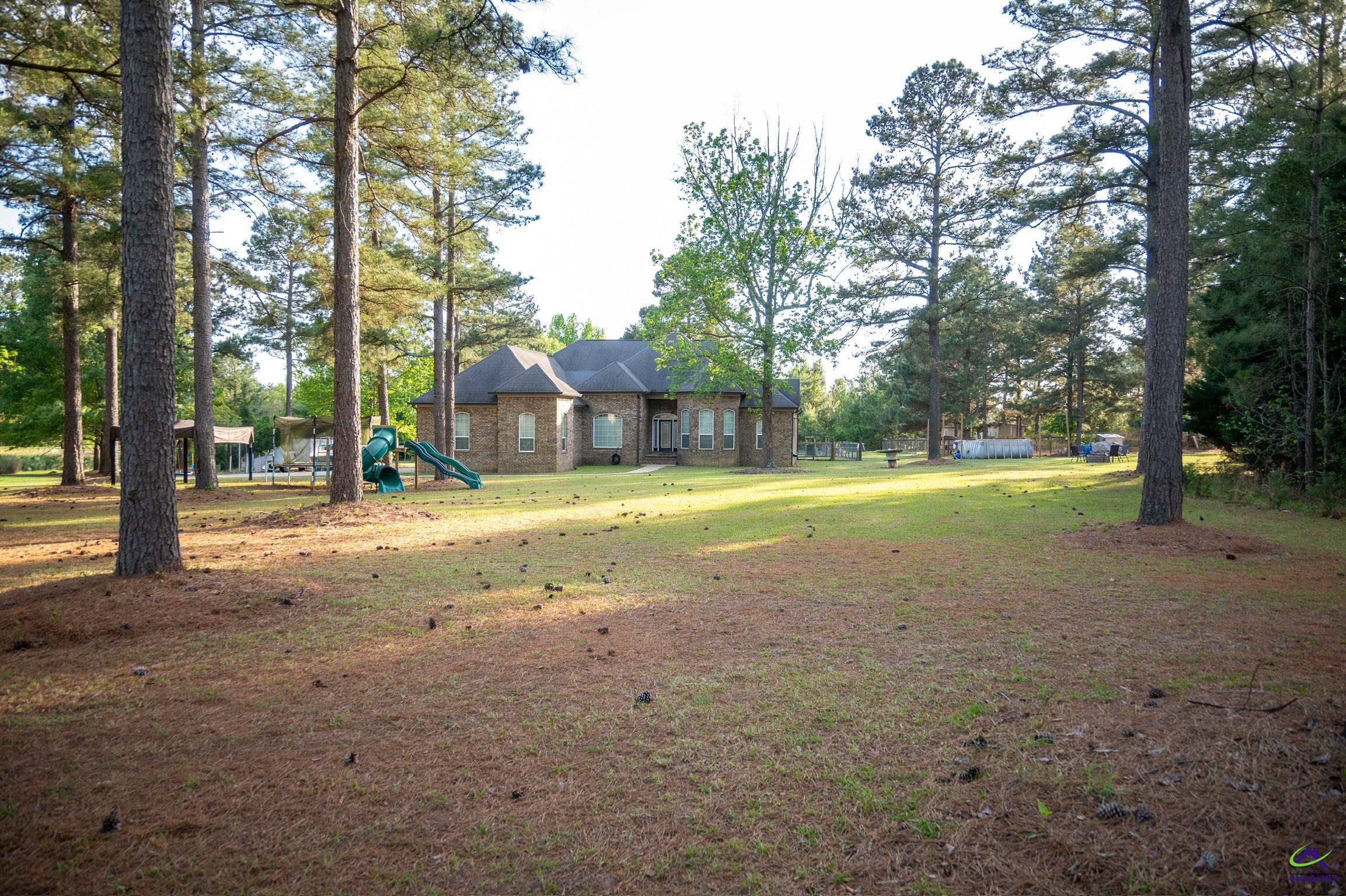 1060 Edna Moore Road Eastman, GA 31023 - Photo 5 of 87 a view of a house with a yard and tree s