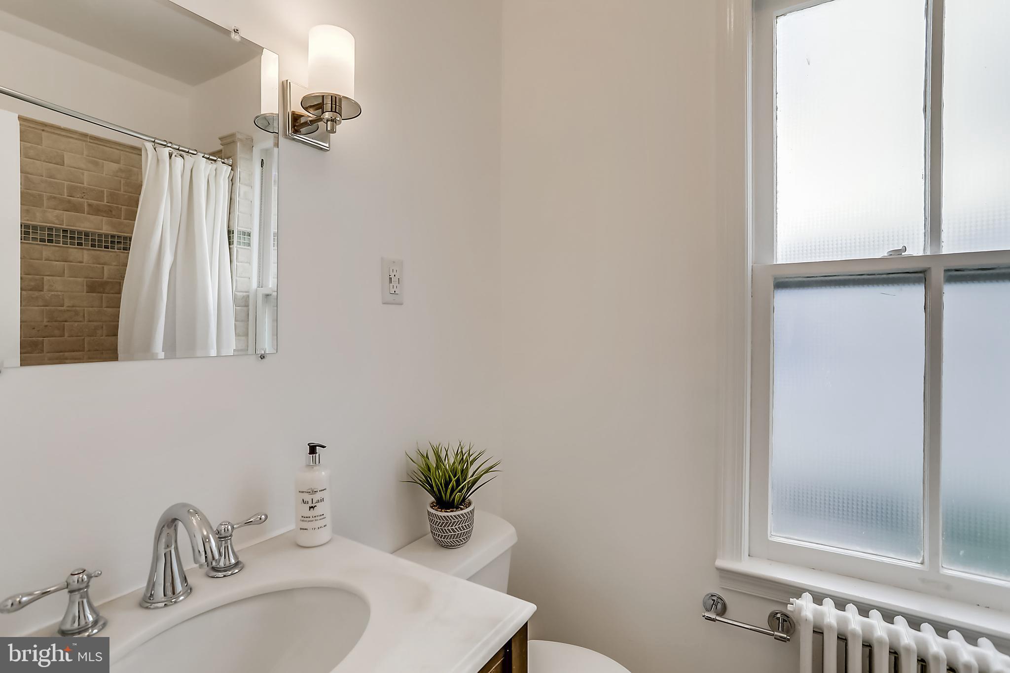 624 Ritchie Avenue Silver Spring, MD 20910 - Photo 15 of 46 Marble topped vanity with sconce lighting