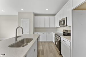 2760 River Meadow Spring Hope, NC 27882 - Photo 11 of 42 a kitchen with sink a stove and cabinets