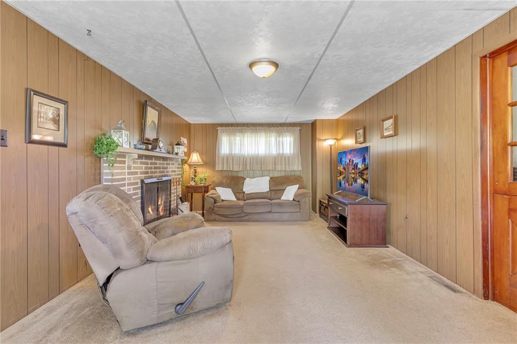 383 Ridgemont Drive Midland, PA 15059 - Photo 28 of 44 a living room with furniture and a flat screen tv