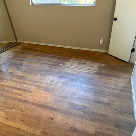 a view of a room with wooden floor