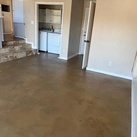 an empty room with cabinet and mirrors