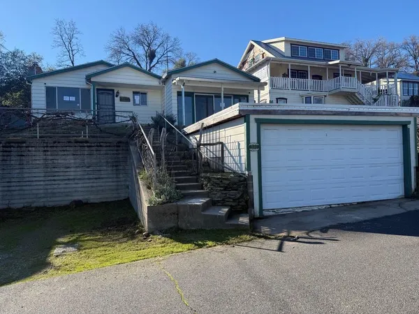 a view of a house with a wooden fence