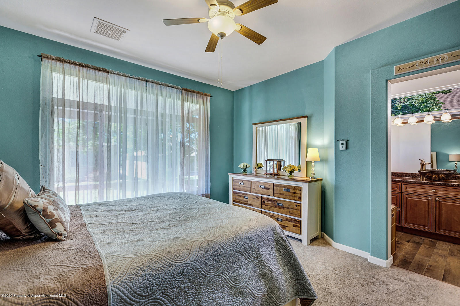 12 Poppy Court Parachute, CO 81635 - Photo 15 of 25 a bedroom with a bed and a chandelier