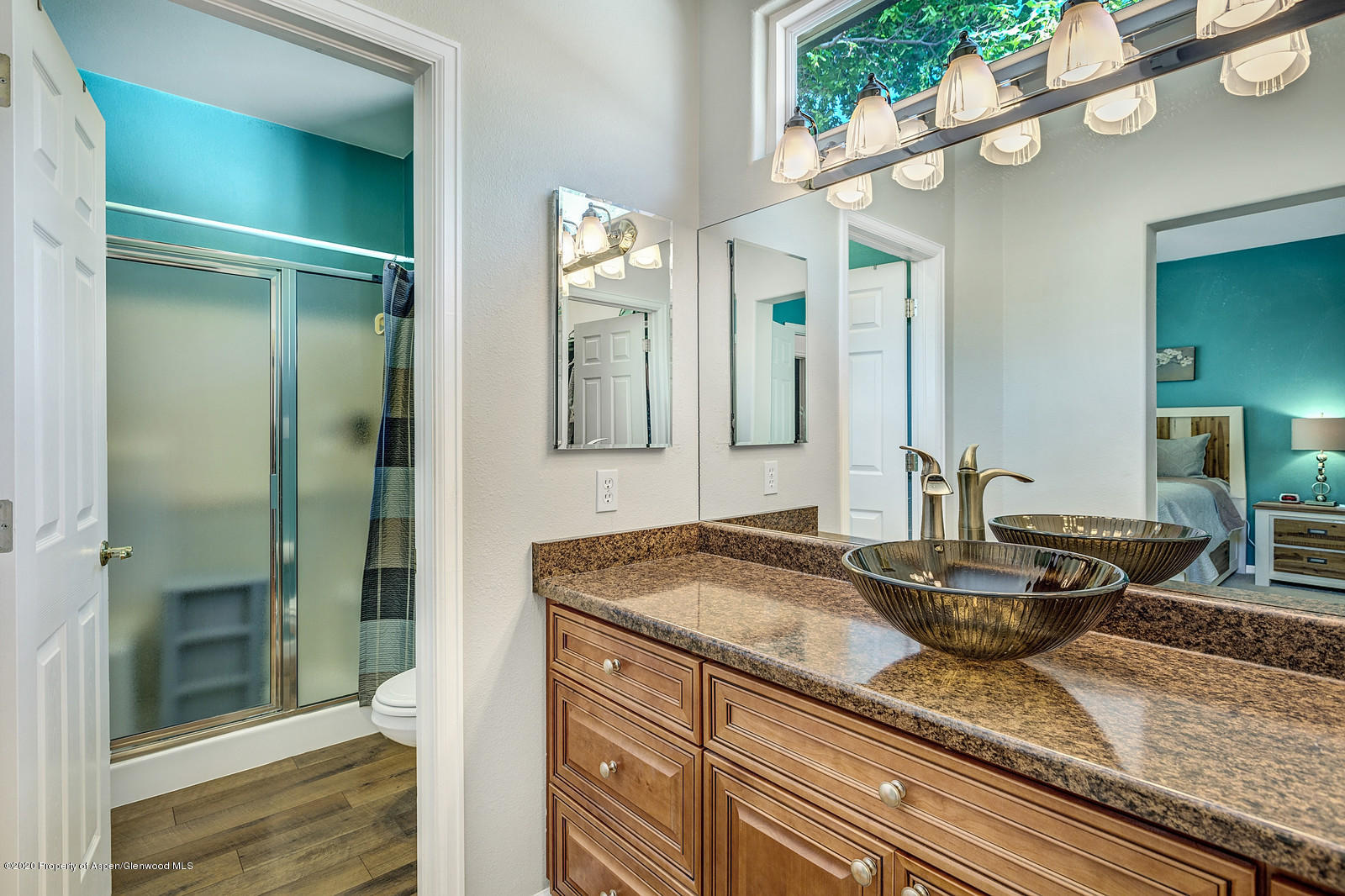 12 Poppy Court Parachute, CO 81635 - Photo 17 of 25 a bathroom with a granite countertop double vanity and a mirror