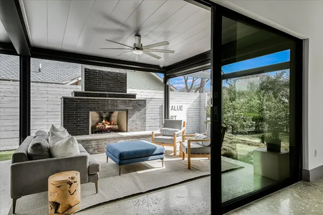 a living room with furniture and a book shelf