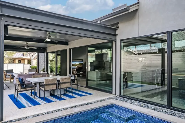 a view of a wooden house with a small yard