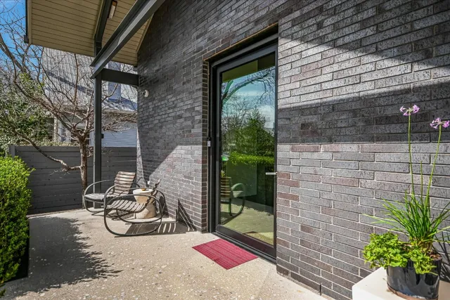 a living room with furniture a clock and a flat screen tv