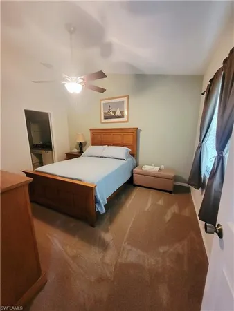 a bedroom with a bed and chair