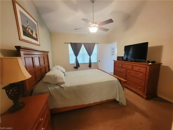 a bedroom with a bed and a flat screen television