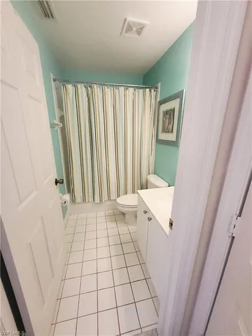 a view of an empty room and a window