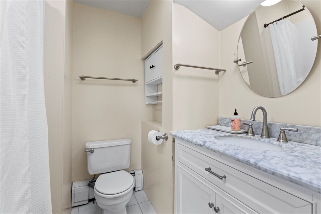 41 Baker Avenue Lexington, MA 02421 - Photo 16 of 21 a bathroom with a granite countertop toilet sink and mirror