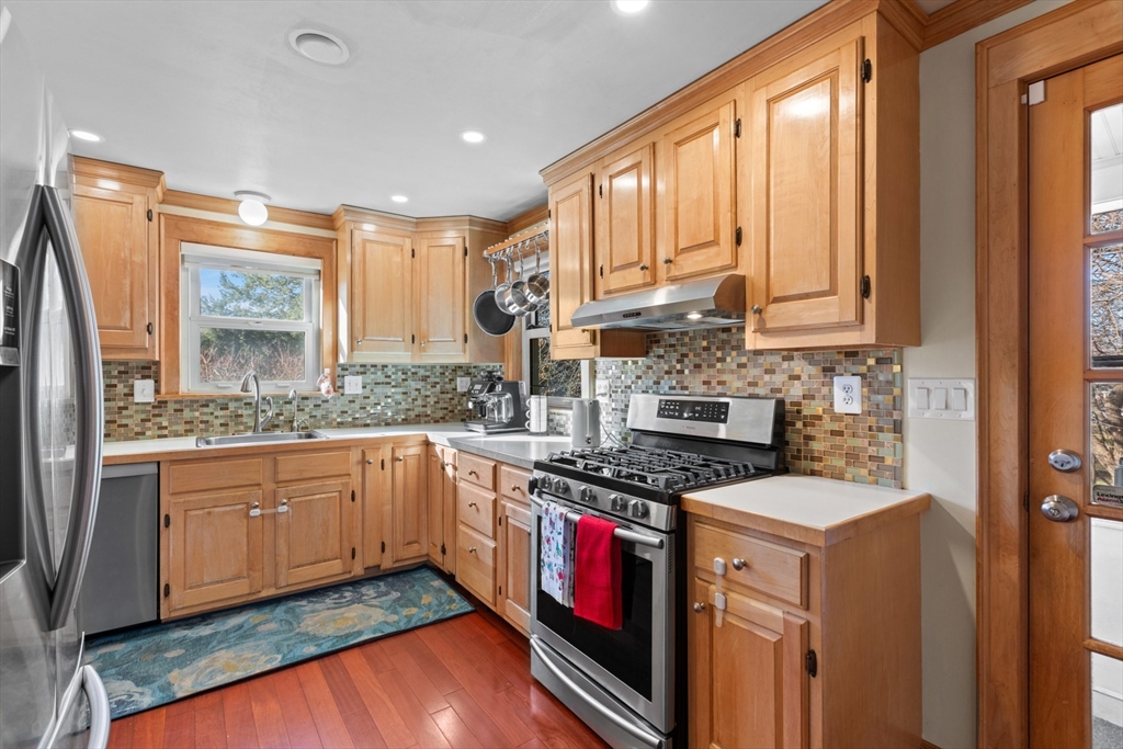 41 Baker Avenue Lexington, MA 02421 - Photo 4 of 21 a kitchen with stainless steel appliances granite countertop a stove a sink and a refrigerator