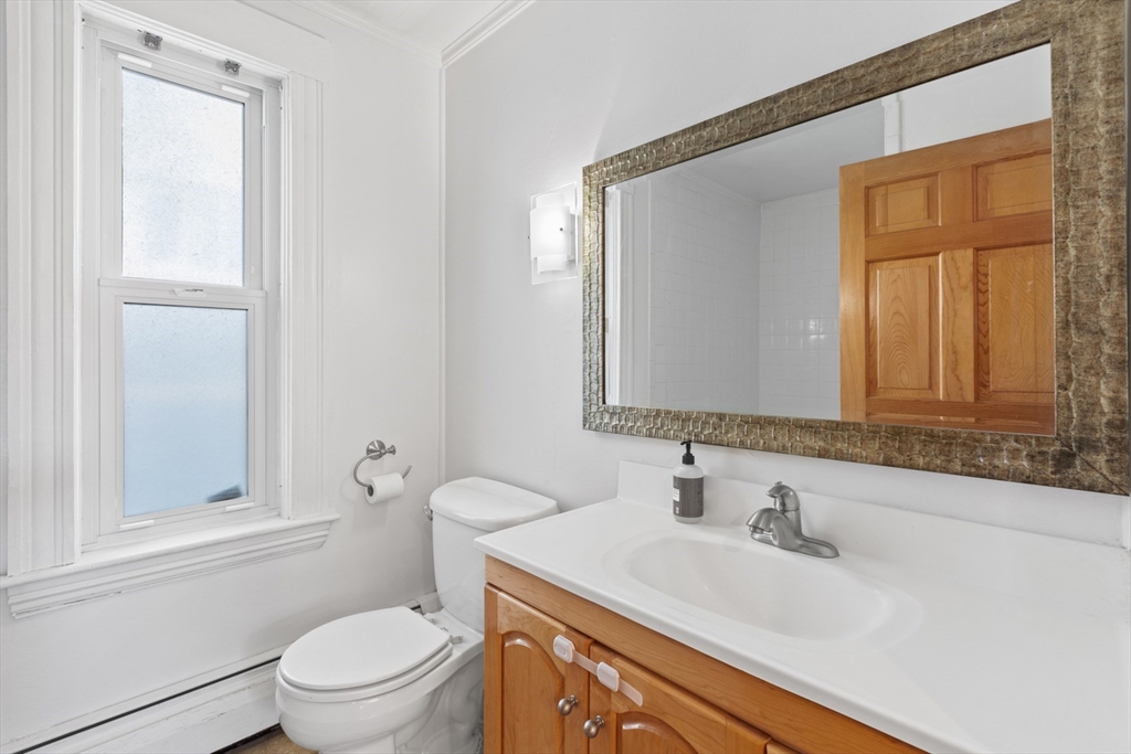 41 Baker Avenue Lexington, MA 02421 - Photo 5 of 21 a bathroom with a granite countertop sink toilet and mirror