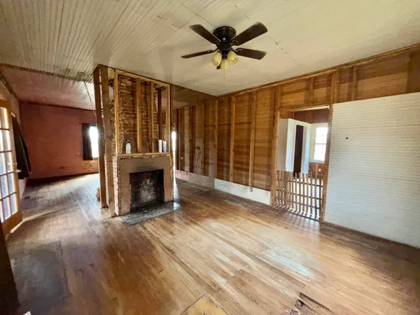 a view of a livingroom with a fireplace and a hallway