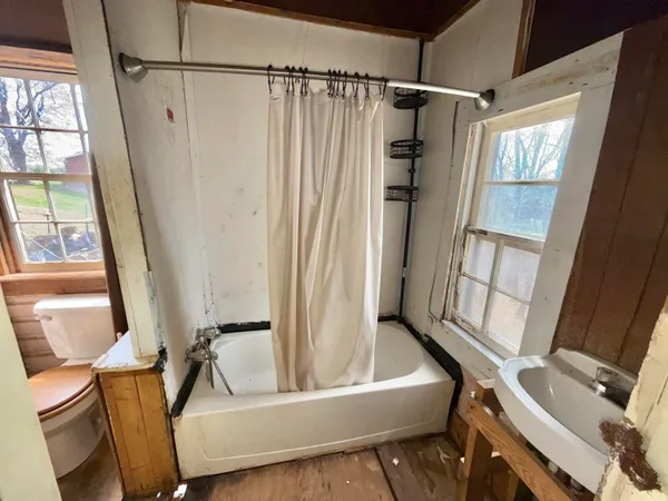 a bathroom with a tub and a window