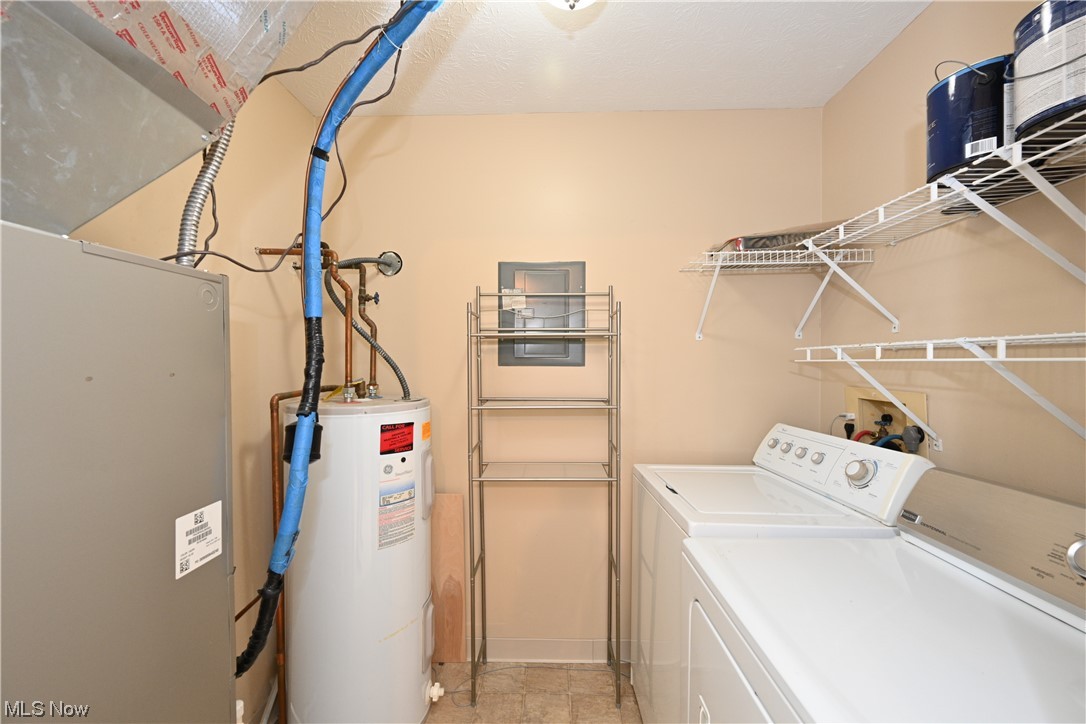 28140 Detroit Road, Unit A1 Westlake, OH 44145 - Photo 8 of 30 Laundry area with light tile floors, independent washer and dryer, hookup for a washing machine, and electric water heater