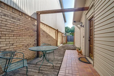 a view of a balcony with chair and table