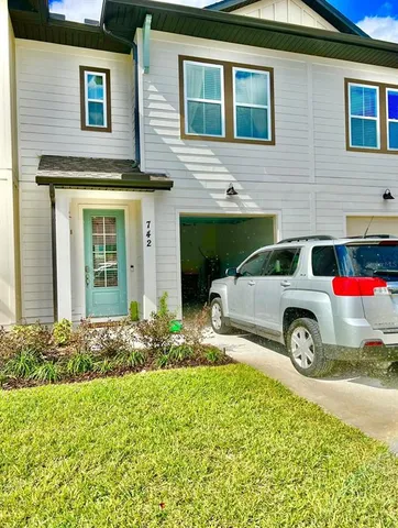 a car parked in front of a brick house