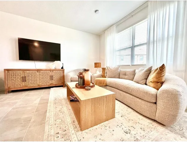 a living room with furniture and a flat screen tv