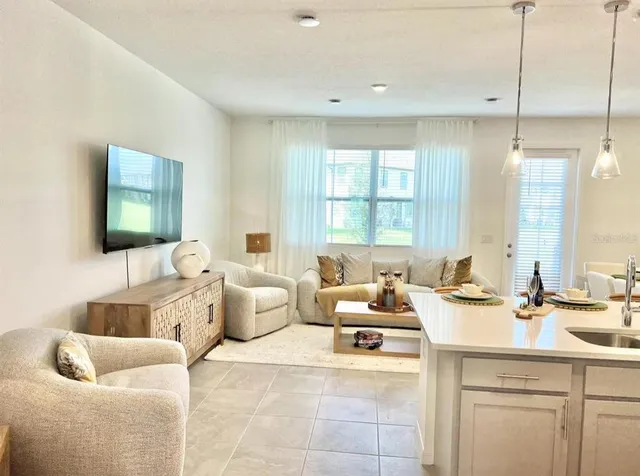 a living room with furniture and a large window