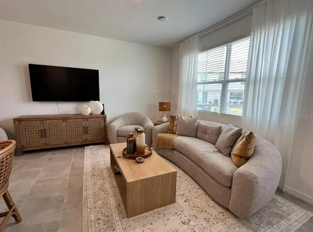 a living room with furniture and a flat screen tv