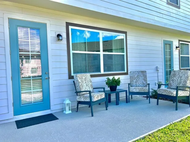 a balcony with furniture and a potted plant