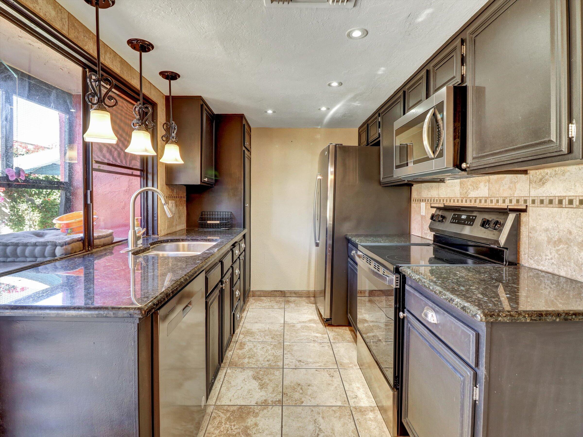525 South Thornhill Road Palm Springs, CA 92264 - Photo 35 of 61 a kitchen with stainless steel appliances granite countertop a sink stove and refrigerator