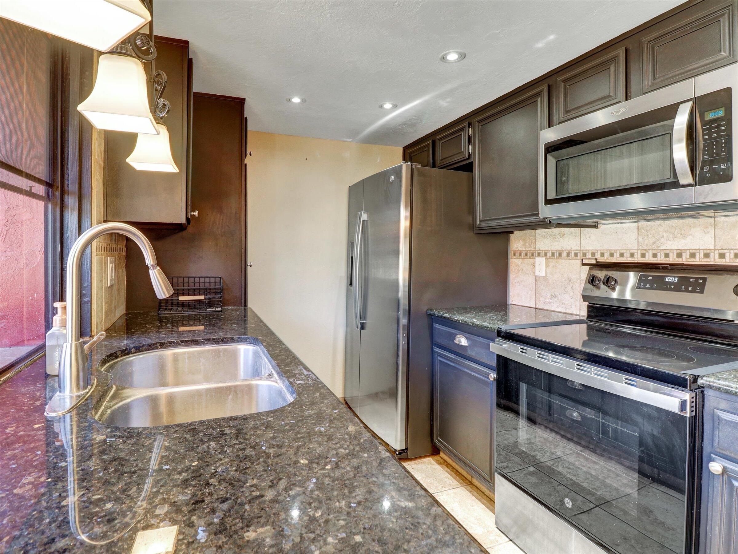 525 South Thornhill Road Palm Springs, CA 92264 - Photo 36 of 61 a kitchen with stainless steel appliances granite countertop a sink and a stove