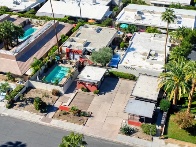 an aerial view of residential houses with outdoor space and street view