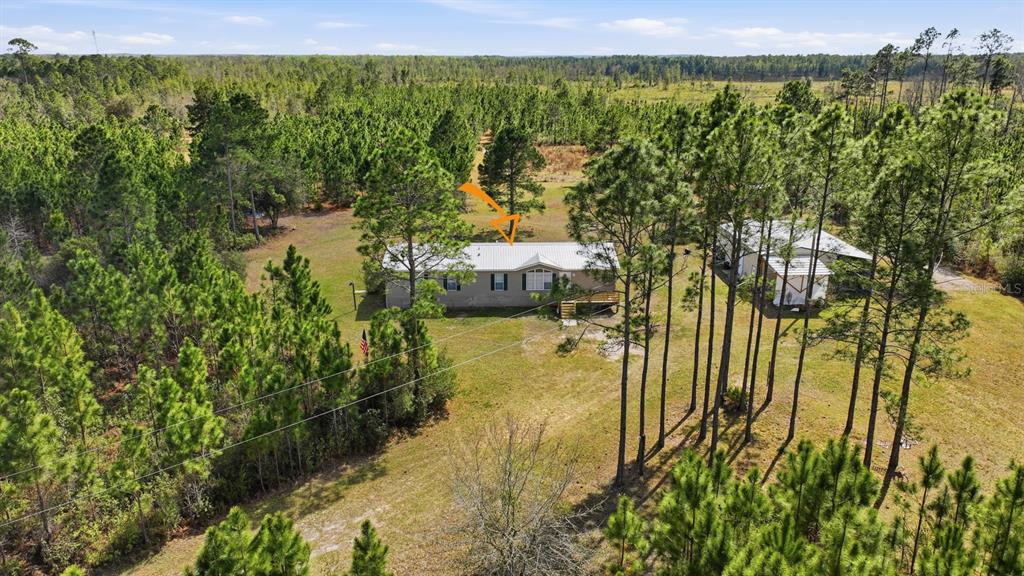 299 Cayenne Street Interlachen, FL 32148 - Photo 1 of 1 a view of a lake with a building in the background