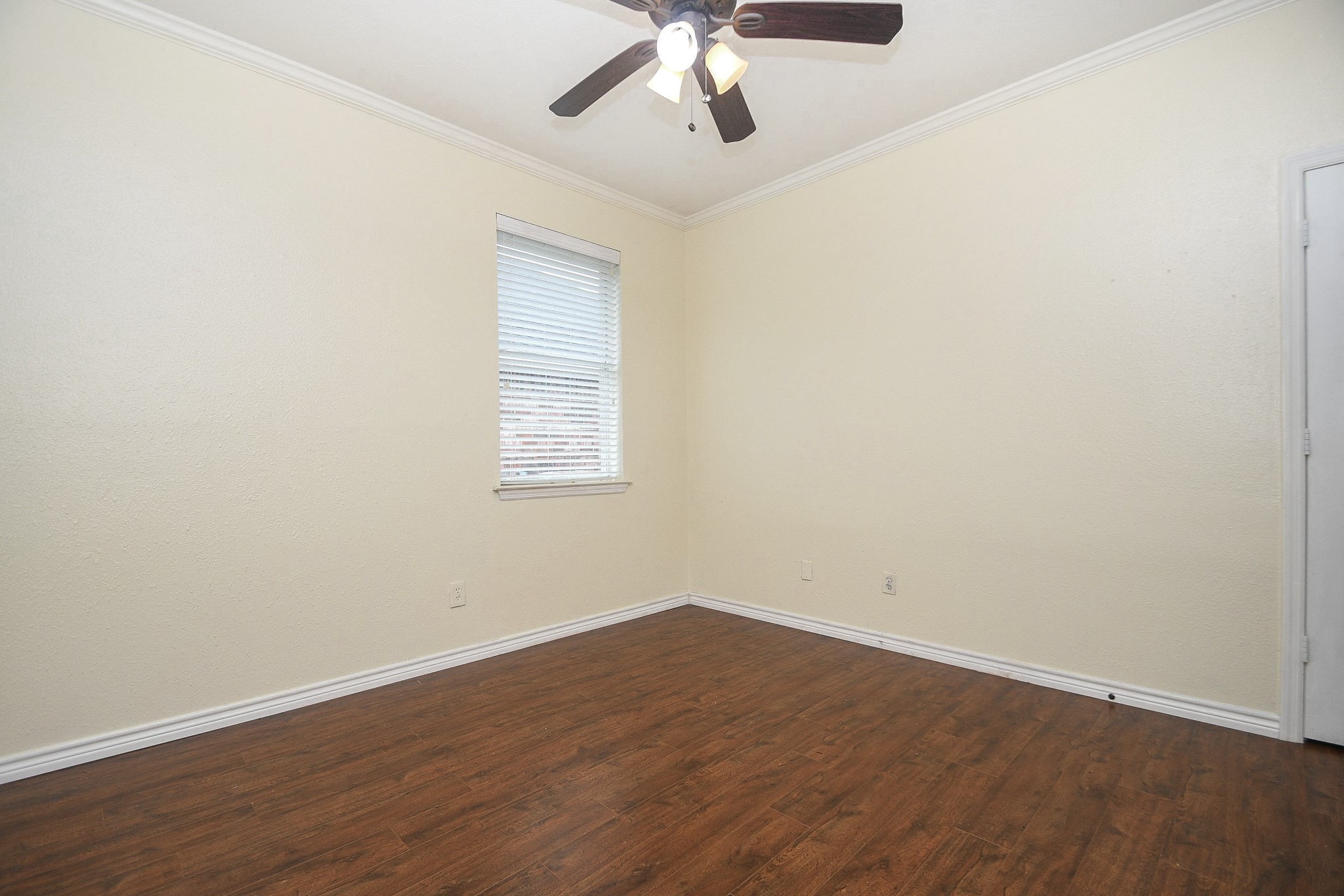 5602 Walkabout Way Katy, TX 77450 - Photo 27 of 33 an empty room with wooden floor fan and windows