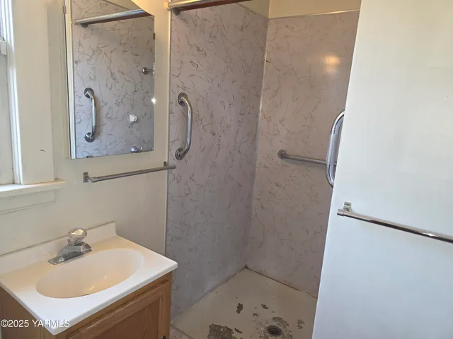 a bathroom with a sink and mirror with toilet