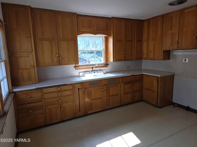 a kitchen with sink and cabinets