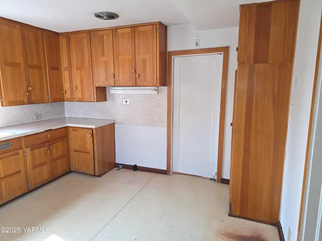 a view of a kitchen with appliances and cabinets