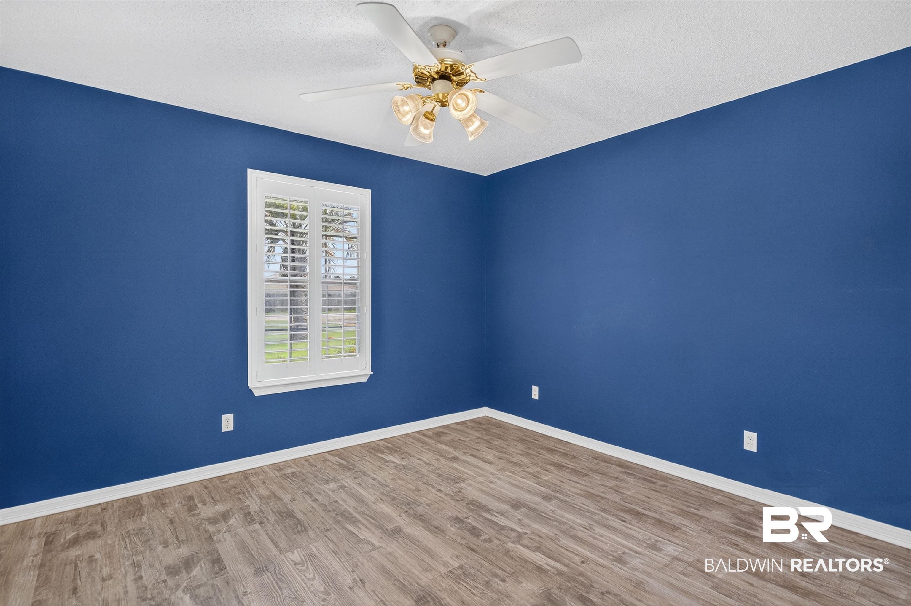 22685 County Road 12 Foley, AL 36535 - Photo 62 of 89 Room featuring wood-finish flooring and a single window with white plantation shutters