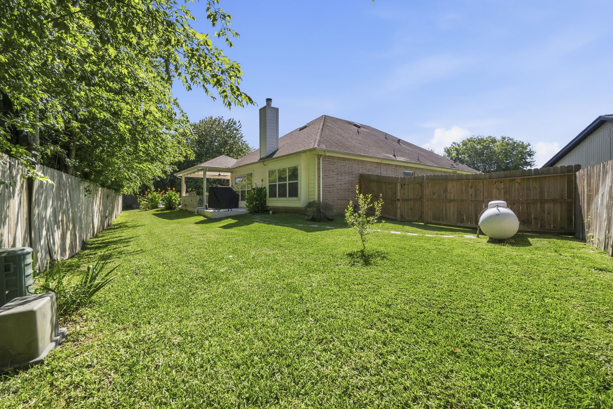 10802 Windswept Montgomery, TX 77356 - Photo 42 of 42 a backyard of a house with table and chairs