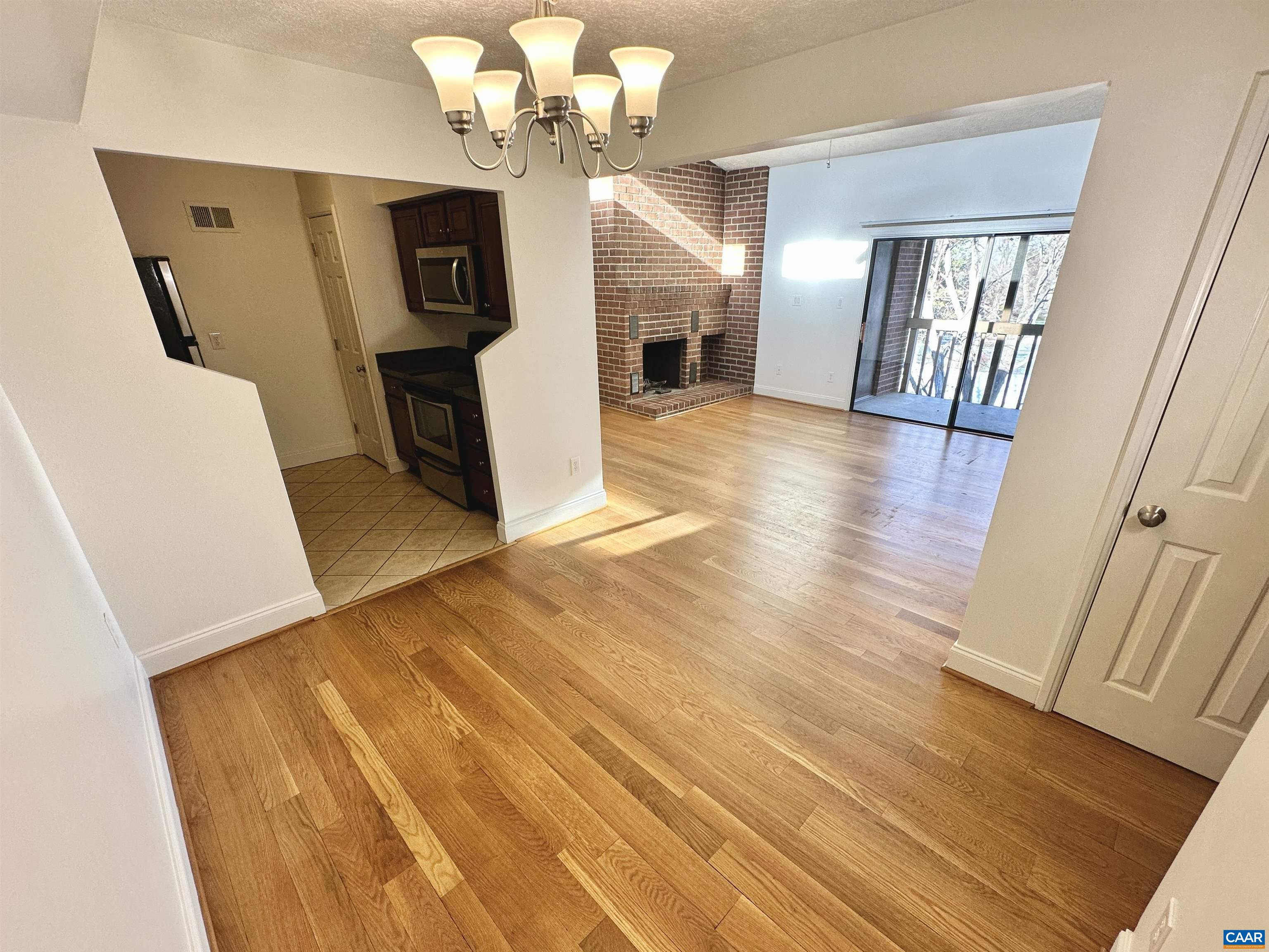104 Turtle Creek Road, Unit 9 Charlottesville, VA 22901 - Photo 4 of 23 a view of a hallway with wooden floor and staircase