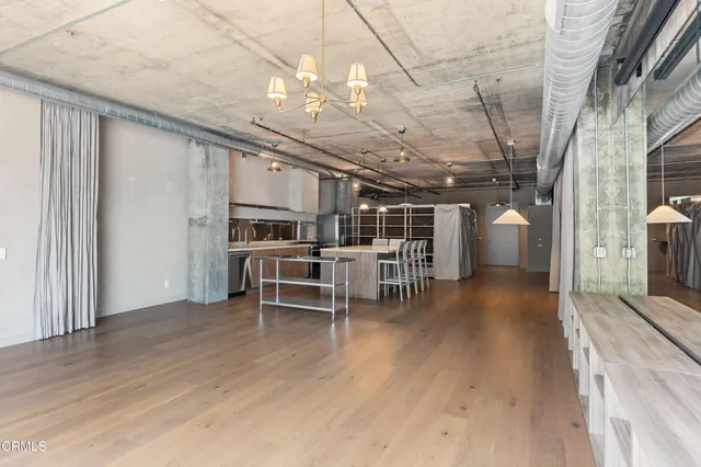 a view of a livingroom with furniture and a kitchen