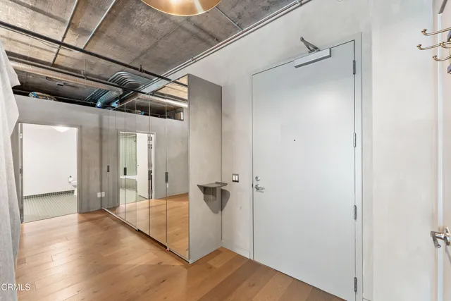 a view of a hallway with wooden floor