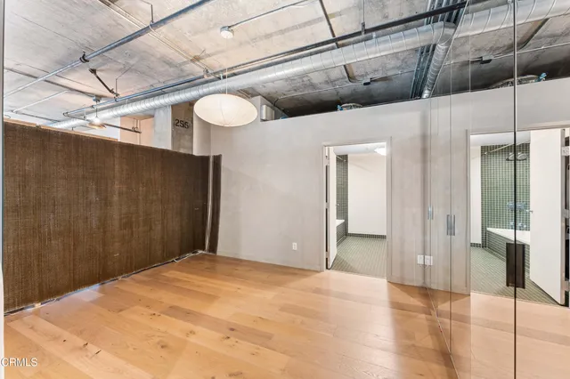 a view of a hallway with wooden floor