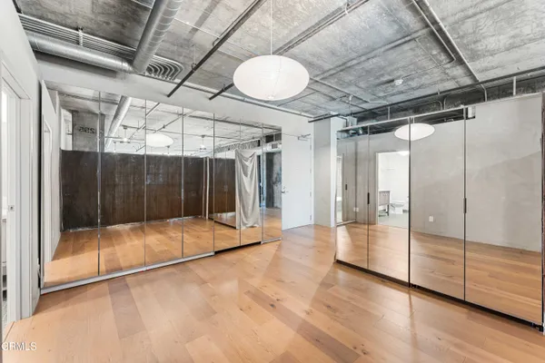 a view of a room with wooden floor