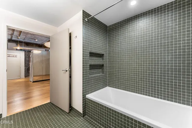 a bathroom with a bathtub and a shower