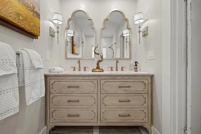 a bedroom with a bed table and a flat screen tv