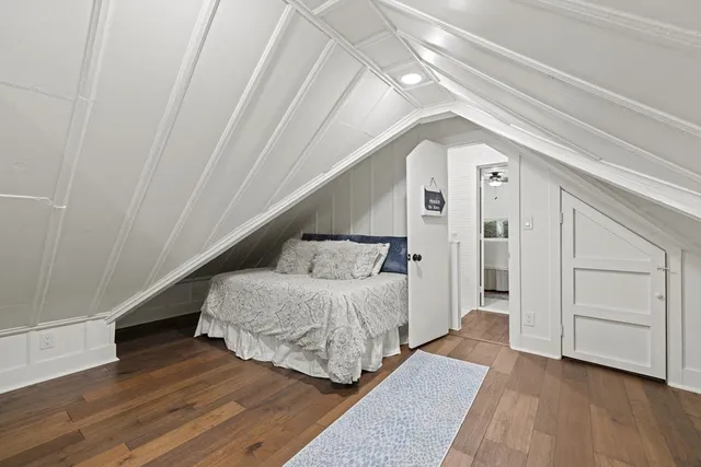 a view of a patio with table and chairs potted plants and large tree