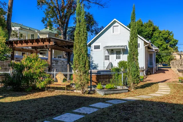 a view of a chairs and table in patio with wooden floor