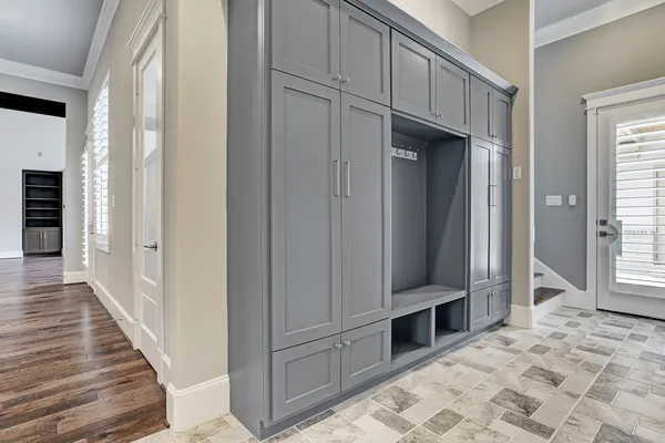 a view of a hallway with closet and cabinet