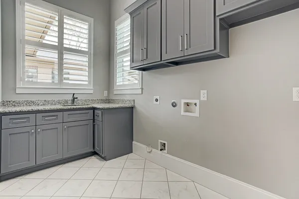 a bathroom with a granite countertop sink and cabinets