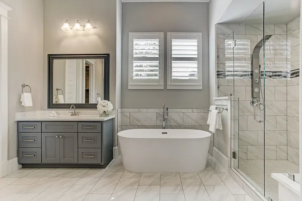 a view of a bathroom with mirror bathtub and shower